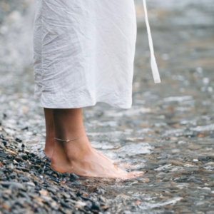 Woman's feet on a pebble beach